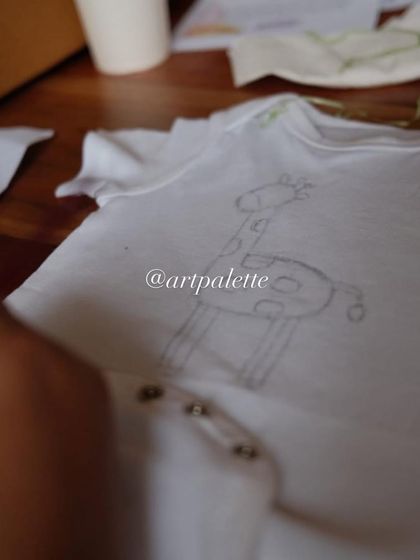 Before the color comes the sketch. For my onesie painting parties, I provide pre-sketched outlines like this little giraffe to make it easy and enjoyable for everyone, no matter their skill level.