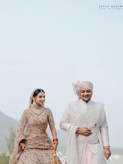 A quiet walk together. I styled this couple in soft, coordinated pastel outfits, creating a serene and romantic portrait against the hazy mountain backdrop of Udaipur.