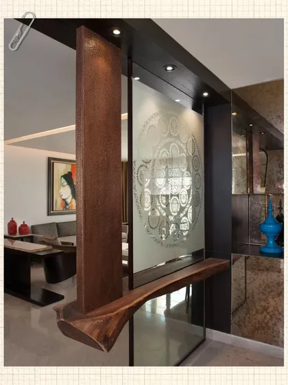 A wider view of the Sanjhi paper-cut screen, integrated into a modern partition with a live-edge wood shelf. This piece acts as both a functional divider and a work of art.