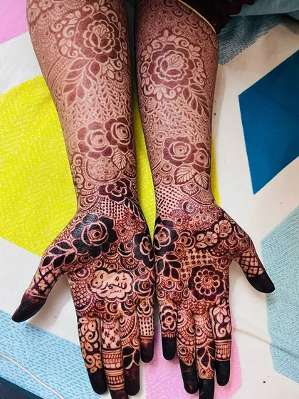 The full view of the stain, showing the intricate floral patterns on the palms and the lighter, delicate design on the arms.
