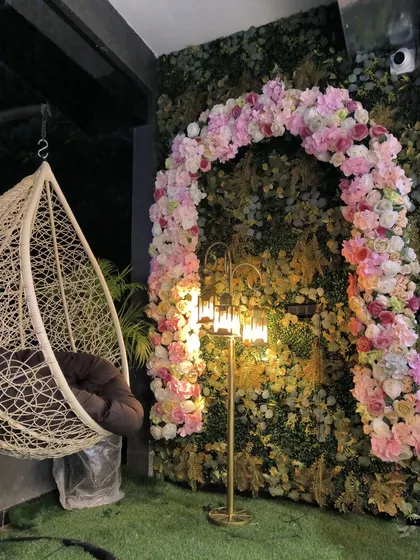 For a salon entrance, we created this grand floral arch over a vertical garden wall. It makes a huge first impression. I can create custom designs like this for homes, cafes, or any commercial space.