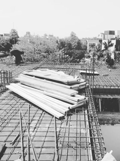 Work progressing on the roof slab. The intricate grid of steel reinforcement is being prepared for the concrete pour, a critical step in the structural phase.