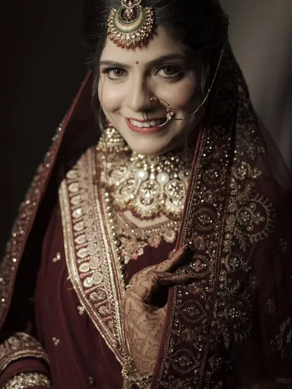 A happy and engaging portrait of the bride, looking directly at the camera with a genuine smile.