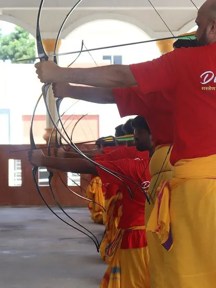 Students of all body types learn to adapt the techniques to their own strength. Here, a student receives guidance on his draw, ensuring he builds power and accuracy safely.