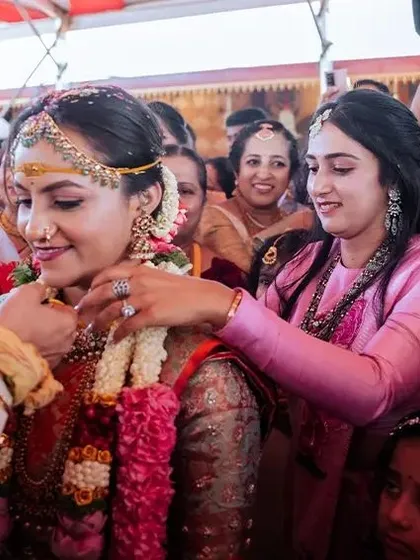 The warmth of family is a central part of any wedding. This shot shows a family member helping the bride during the ceremony, a perfect example of the candid, meaningful interactions we aim to capture.