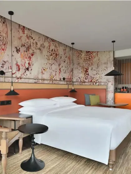 A custom wall mural in a suite at The Artiste, Kochi, inspired by the traditional Indian dance forms of Bharatnatyam and Teyyam, weaving local culture into the room's design.