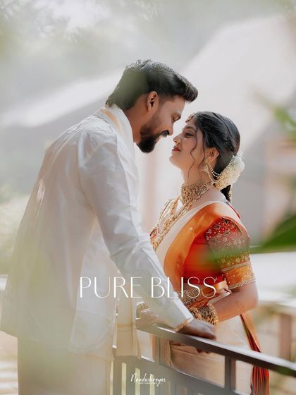 "Pure Bliss." The couple shares an intimate gaze on a balcony, framed by soft light that enhances the romantic and serene mood.