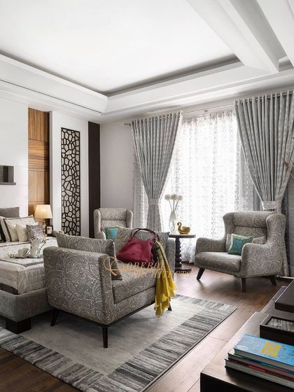 The room is well-lit, with large windows and beautiful curtains that complement the sophisticated aesthetic.