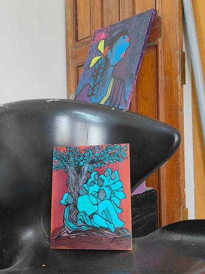 The same painting, "My Grandma is a tree now!", shown in my workspace. Seeing the art in its environment gives a sense of the creative process and the space where these ideas come to life.