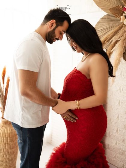 An intimate moment of connection. This pose, with foreheads touching, is a beautiful way to capture the quiet love and anticipation between expecting parents.