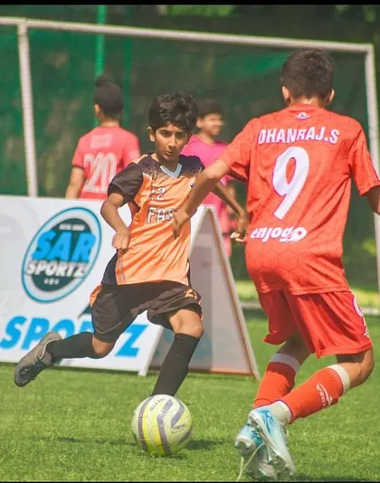 A young attacker running towards the goal during a Pride Cup match.