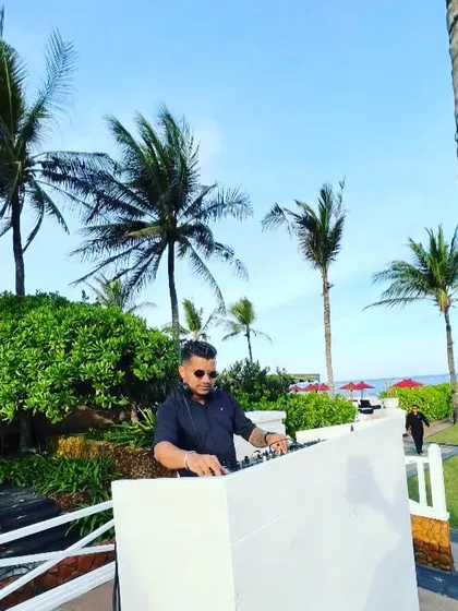 A beautiful beachside setup with palm trees and a clear blue sky. I travel the world to bring my music to the most amazing locations.