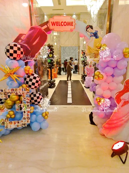 A creative combination of themes for siblings, this entrance features a car-themed arch on one side and a princess-themed arch on the other.
