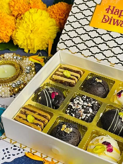 A beautiful Diwali gift box filled with an assortment of our festive treats. The box includes a variety of chocolate truffles and other bite-sized sweets, perfect for gifting.