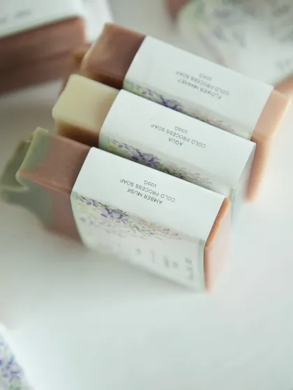 A trio of the custom-wrapped soaps, showing the different variants inside.