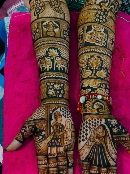 A beautiful example of narrative mehndi art. The palms feature portraits of the bride and groom, while the arms depict traditional wedding symbols like the kalash and auspicious peacocks.