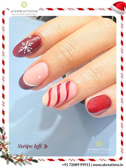 This mixed-design Christmas manicure includes a glittery red nail with a snowflake, a French tip, and a fun candy cane swirl pattern.