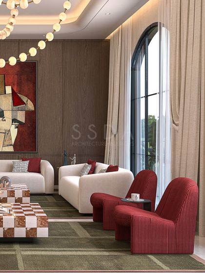 This detail shot highlights the pairing of deep red armchairs with a wood-panelled accent wall. The combination of warm wood and rich color creates a cozy yet sophisticated corner within the larger living space.