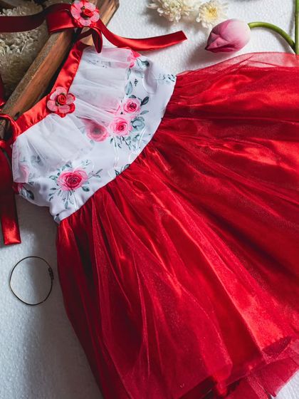 A styled photo of the red and white floral dress, emphasizing its romantic and festive qualities. It's a perfect choice for a holiday party or special celebration.