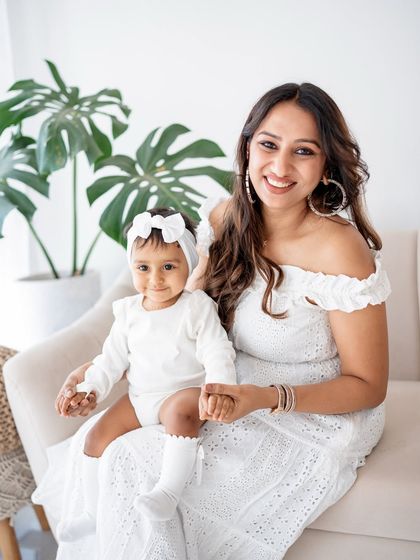 A beautiful mother-daughter portrait. Their coordinating white lace outfits are so lovely.
