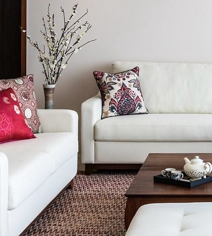 The living room of the Terrazzo Residence is a blend of comfort and style. The white sofas keep the space feeling bright, while the patterned rug and cushions introduce texture and a warm, lived-in quality.