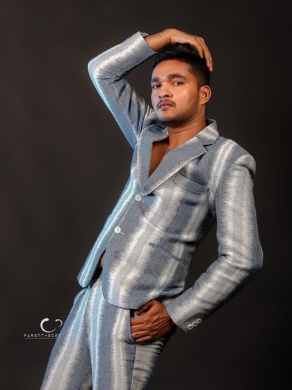 A classic male model pose that highlights both the garment and the subject's physique. The lighting is clean and focused, creating a sharp, professional look.