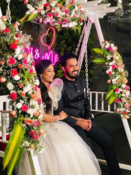 A romantic floral swing we curated for a beautiful couple. The swing is adorned with fresh flowers and a custom "You & Me" neon sign, creating the perfect picturesque photo booth for any pre-wedding event or reception.