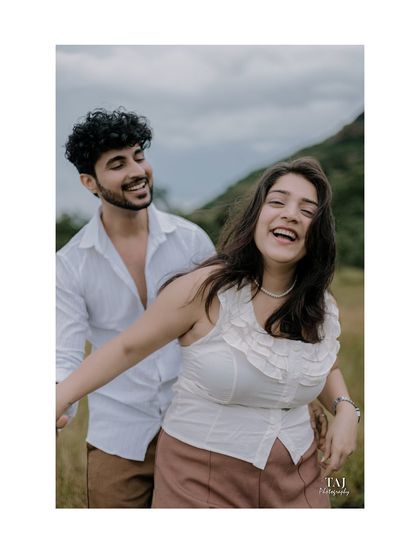 Pure, unscripted joy. This candid photo captures a moment of genuine laughter and fun as the couple enjoys their time together in a beautiful natural setting.