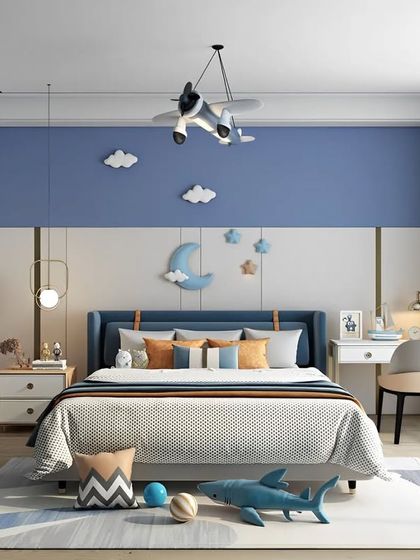 A boy's bedroom with a cool blue and white nautical theme, featuring a custom headboard, airplane-themed light, and a dedicated study desk.