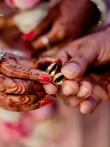 A close-up shot of the couple's wedding rings, a symbol of their union.