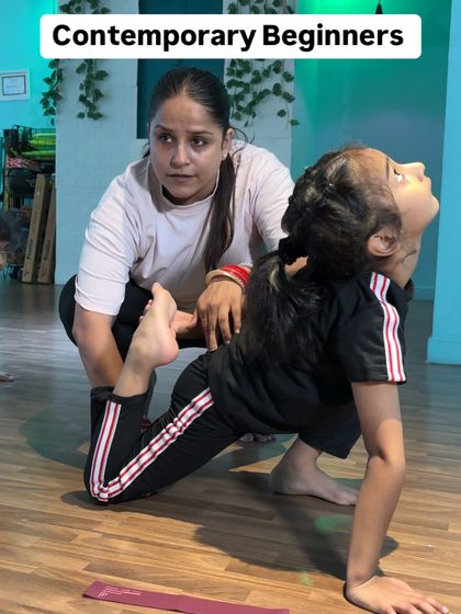 Correcting the form for a deep lunge with a backbend. This pose requires both flexibility and strength, and my hands on support helps the student find her balance and proper alignment.