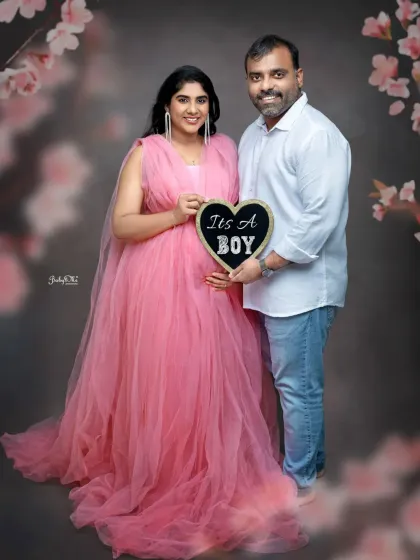 A classic couple maternity portrait announcing "It's a Boy!". The mom-to-be looks like a princess in this flowy pink tulle gown from my client closet, perfect for celebrating a new beginning.