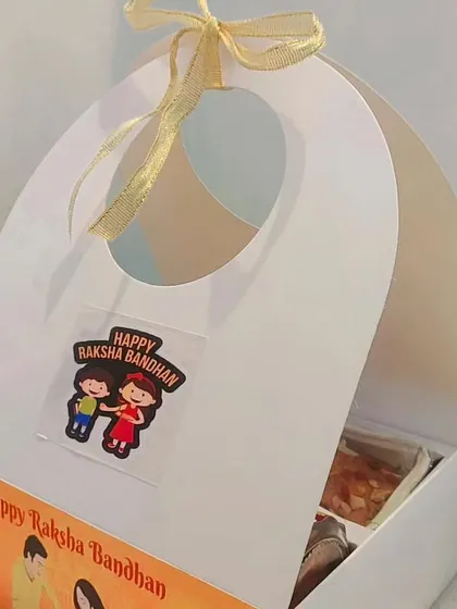 A budget-friendly Rakhi hamper in a carry box with a window.
