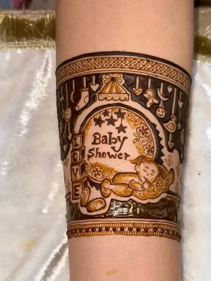 I design mehandi for all of life's special moments. This is a custom design I created for a baby shower, featuring adorable motifs to celebrate the new arrival.