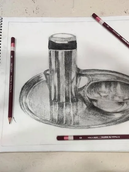 The final sketch in the artist's workbook, surrounded by the tools of the trade. We encourage students to practice regularly to hone their skills.