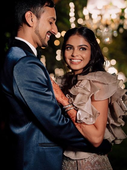 A beautiful candid moment between the happy couple. Her makeup looks flawless and radiant, even in a spontaneous, happy shot.
