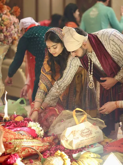 Participating in rituals during our pre-wedding ceremony. The way his simple pearl necklace echoes the details in my jewelry is a small but impactful styling choice for a cohesive look.