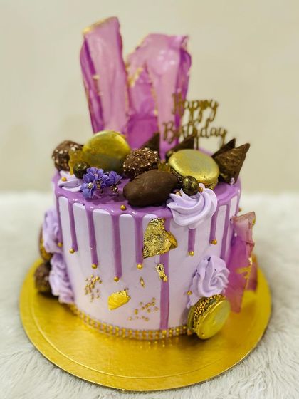 A close-up of the rich toppings on the lavender drip cake.