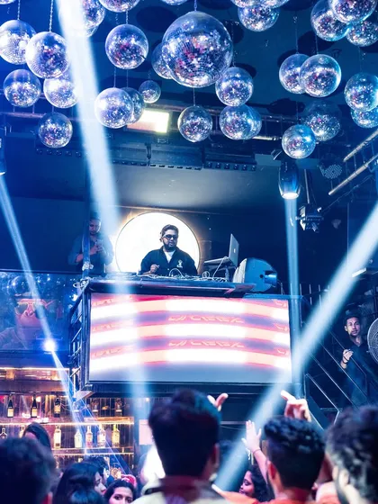 I love creating moments that feel bigger than just being an artist on stage. Here I am, commanding the stage under the disco balls at a premium nightclub.