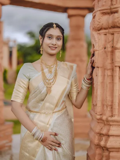 A warm and welcoming portrait of the bride looking directly at the camera with a gentle smile.