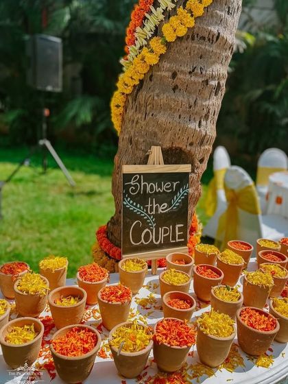 A lovely detail for a Haldi ceremony: small clay pots filled with flower petals for guests to shower the couple.