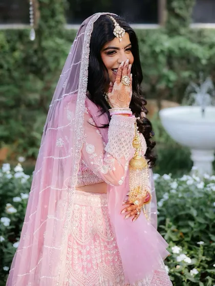 The most beautiful part of any bridal look is the bride's happiness. This candid moment captures the pure joy and confidence that comes from feeling like the most beautiful version of yourself on your special day, which is always my ultimate goal.