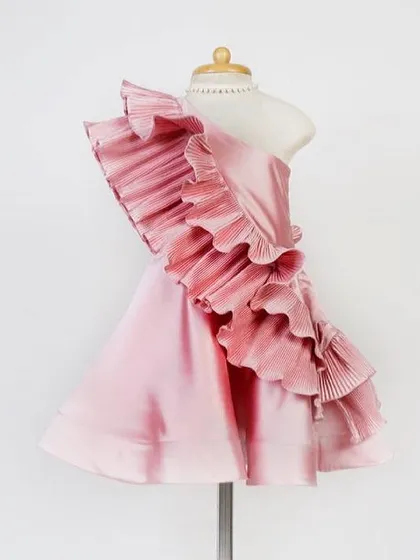 Our bestselling "Blush Desire" dress. This one-shoulder design with its cascade of micro-pleated ruffles is a showstopper, crafted from elegant blush pink satin.