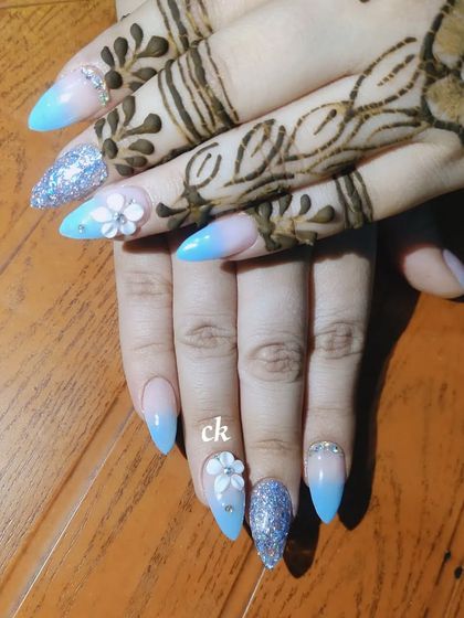 A closer look at the blue ombre bridal nails with glitter and 3D flower details.