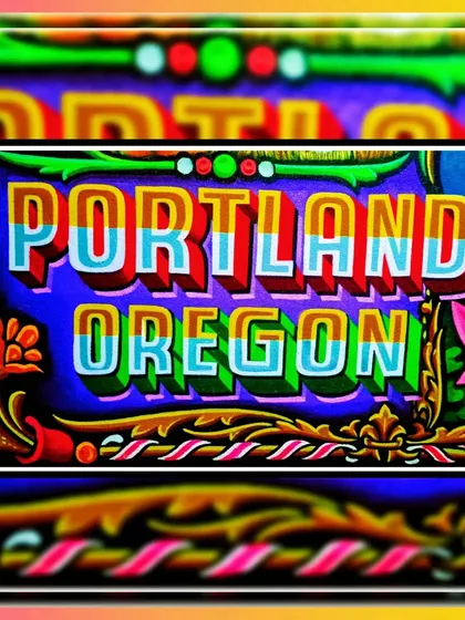 A detail shot of the "Portland Oregon" lettering from the Oddball Tattoo sign, showcasing a multi-colored 3D effect.