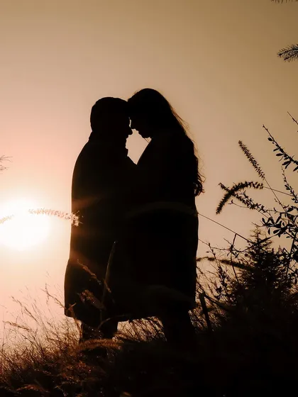 A perfect silhouette against a golden sunset in the hills of Shimla. Destination pre-wedding shoots like this are all about finding those magical moments where it feels like you're the only two people in the world.