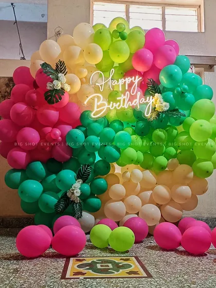 This vibrant, full-circle balloon arch creates a fantastic photo backdrop for a birthday party. We used a mix of bright colors and a central neon 'Happy Birthday' sign to make it pop.