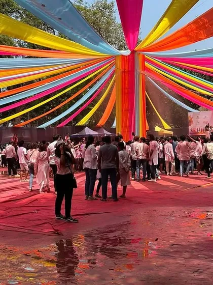 The 'Rang De' Holi Bash at Dadar's BMC Ground was a huge success. I set up the entire venue, including this vibrant, multi-colored fabric canopy that covered the ground, creating a festive mood for the massive, houseful crowd.