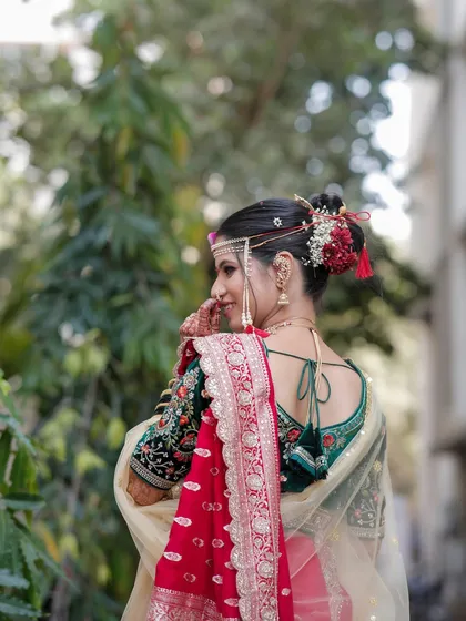 A view of the traditional Khopa bun hairstyle, adorned with fresh flowers. This is a key element of the classic Maharashtrian bridal look.