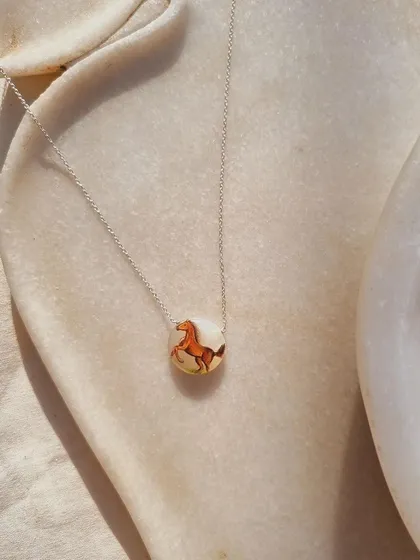 Another view of the "Oliver's Horse" pendant. The white moonstone base provides a beautiful canvas and adds the energy of abundance.